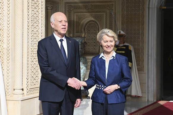 In this photo provided by the Tunisian Presidency, Tunisian President Kais Saied, left, shakes hand with European Commission President Ursula von der Leyen at the presidential palace in Carthage, Tuni ...